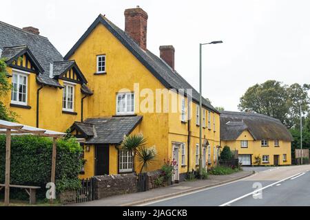 Distinctively painted houses at a village crossroads in East Devon, UK Stock Photo