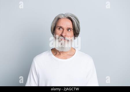 Photo of dreamy thoughtful man pensioner dressed white t-shirt looking empty space isolated grey color background Stock Photo