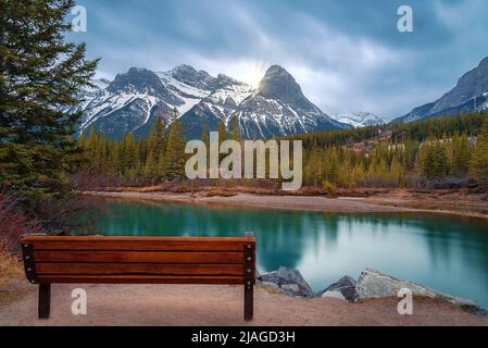Bench Overlooking Canmore Mountains And River Stock Photo