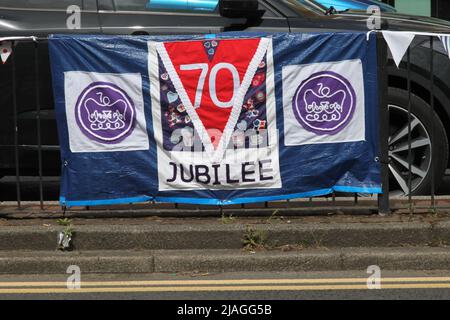 Queen's 70th Jubilee flag banner, Craddock's Parade, Ashtead, Surrey, UK, 2022 Stock Photo