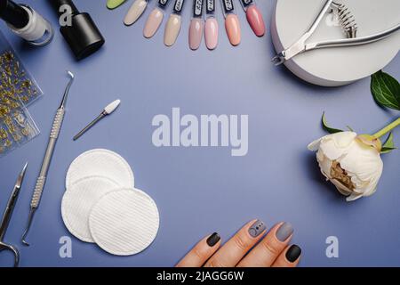 Set of manicure tools and accessories for manicure, nail polish and design on a blue background. Flat lay, top view with Copy space. Stock Photo