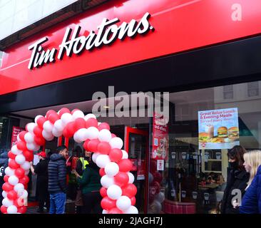 Manchester, UK, 30th May, 2022. A new branch of Tim Hortons, the Canadian coffee shop chain, has opened on Market Street in central Manchester, England, United Kingdom. Part of the Arndale shopping centre, it seats some 100 customers. Tim Hortons serves coffee, doughnuts, and similar fast food items. Tim Hortons, often nicknamed Tim's or Timmies, is a Canadian multinational fast food restaurant chain. It has 4,949 restaurants in 15 countries as of March 2022. Credit: Terry Waller/Alamy Live News Stock Photo