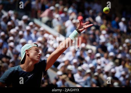 Paris, France. 30th May, 2022. Holger Rune of Denmark serves during the men's singles fourth round match against Stefanos Tsitsipas of Greece at the French Open tennis tournament at Roland Garros in Paris, France, May 30, 2022. Credit: Meng Dingbo/Xinhua/Alamy Live News Stock Photo