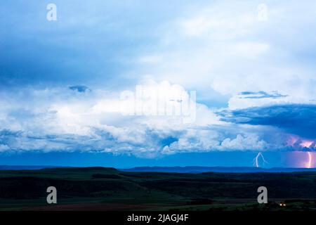 Dark cumulus clouds and lightning after sunset Drakensberg South Africa Stock Photo