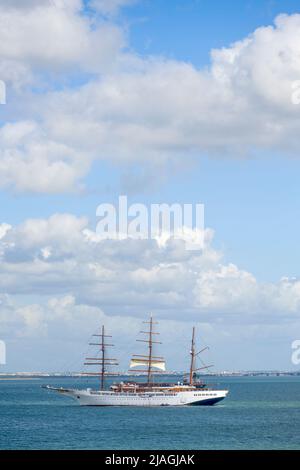 Three masted yacht moored on the River Tagus, off the coast of Lisbon, Portugal Stock Photo