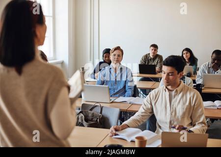 Multiracial students attending lecture in classroom at university Stock Photo