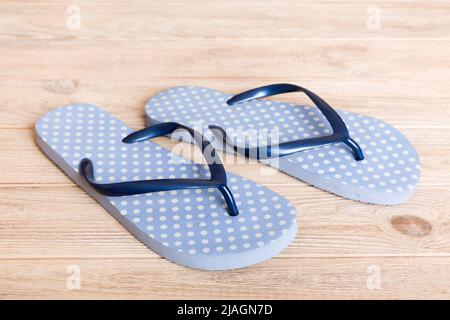 Beach accessories. Flip flops and starfish on colored background. Top view Mock up with copy space. Stock Photo