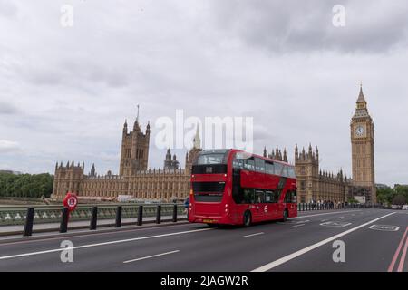 Over cast sky over the Houses of Parliment seen with red London double decker bus on Westminister Bridge, taken 21st May 2022. Stock Photo