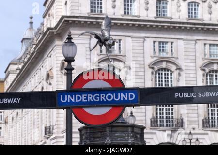 Piccadilly Circus underground sign seen in front of the staue of Eros, taken 21st May 2022. Stock Photo