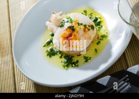 Fried cuttlefish served with green olive oil sauce with garlic and ...