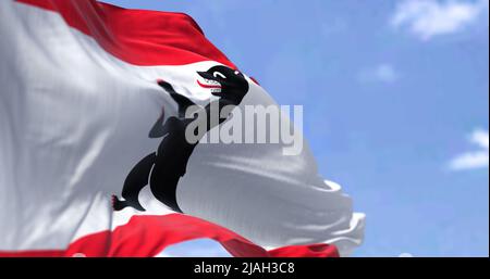 The civil flag of Berlin waving in the wind on a clear day. Berlin is the capital and largest city of Germany by both area and population Stock Photo