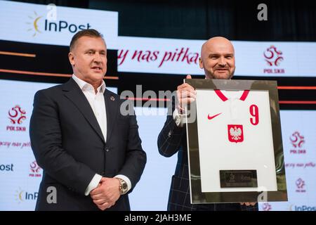Cezary Kulesza and Rafal Brzoska posing with Robert Lewandowski's shirt at the press conference. The Polish Football Association officially announced during a press conference at the National Stadium that InPost became the new strategic sponsor.The conference was attended by PZPN's (Polish Football Association) president Cezary Kulesza and Rafal Brzoska, president of InPost, known as Poland's parcel king, who invented the automated e-commerce lockers. It is estimated that approximately 16 million Poles use InPost's automated parcel lockers. (Photo by Attila Husejnow/SOPA Images/Sipa USA) Stock Photo