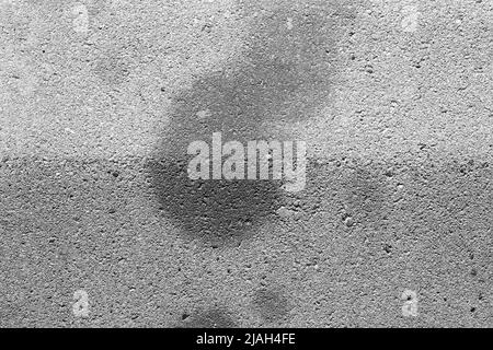 Oil stains on concrete caused by cars. Black engine oil on concrete