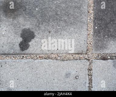Oil stains on concrete caused by cars. Black engine oil on concrete