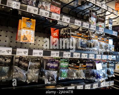 Lynnwood, WA USA - circa May 2022: Angled, selective focus on guitar picks for sale inside a Guitar Center store Stock Photo