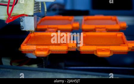 Process printing model on 3d printer. High tech digital printer computer machine in action. Printing mechanism adding layers to object. FDM 3d printer working at 3d printing lab. 3D modern technology. Stock Photo