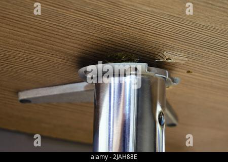 Broken leg of an office desk, repair of furniture made of wood and ...