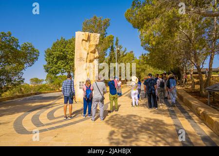 Tourists looking at Carved stone at the entrance to Moses memorial church Mount Nebo Stock Photo