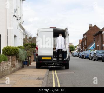 Van illegally parked on a double yellow line and obstructing the pavement for pedestrians. Stock Photo