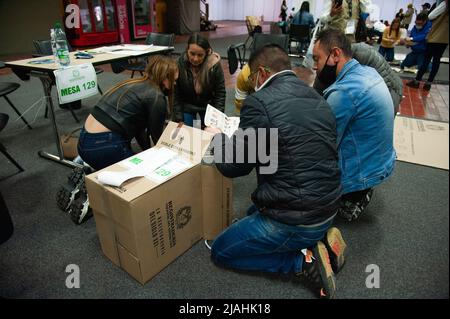 Electoral jury members count votes after elections rally ended during the 2022 Presidential elections in Bogota, Colombia on May 29, 2022. Stock Photo