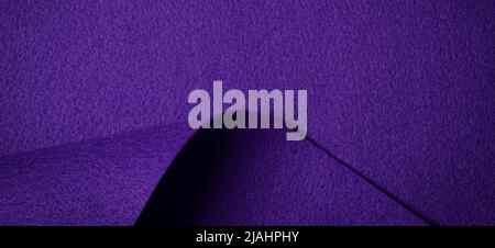 Abstract purple geometric felt texture background. Creative geometric curved felt textile background with copy space. Top view Stock Photo