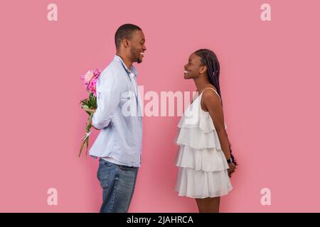 Happy black man making surprise for his woman Stock Photo