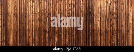 Panoramic wooden wall made of nailed vertical boards Stock Photo