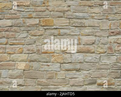 Facade wall with masonry of unequal rectangular bricks. Full screen image. Not seamless texture Stock Photo