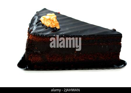 Fudge chocolate cake tart triangular piece made of fudge cake, walnut, butter, vanilla, flour, chocolate and eggs isolated on white background, select Stock Photo