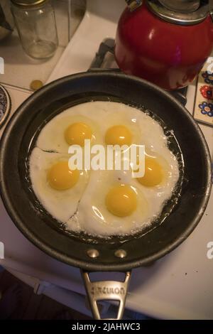 Sunny side up eggs cookling for breakfast on the stove. Stock Photo