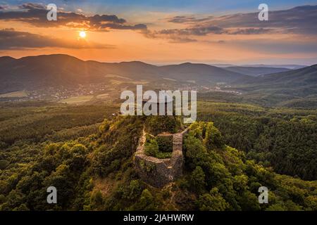 Salgotarjan, Hungary - Aerial view of Salgo Castle (Salgo vara) in Nograd county with a golden sunset sky and green foliage on a summer afternoon Stock Photo