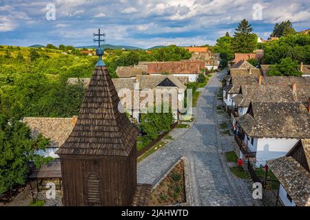 Holloko, Hungary - Aerial view of the tower of the traditional catholic church of Holloko at the village centre, an UNESCO site in Hungary on a sunny Stock Photo