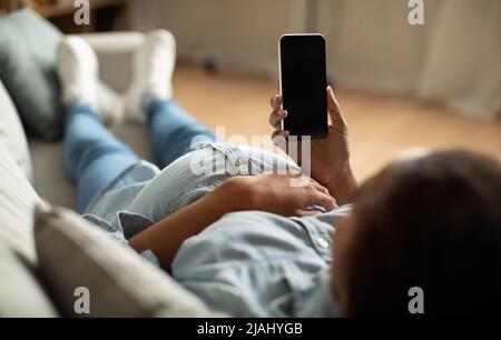 Pregnant African Female Using Phone With Blank Screen At Home Stock Photo