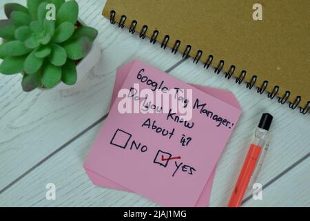 Concept of Google Tag Manager, Do you know about it? Yes write on sticky notes isolated on Wooden Table. Stock Photo