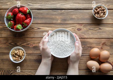 Ingredients for fruit strawberry cake or pie on rustic wooden table, top view. Stock Photo