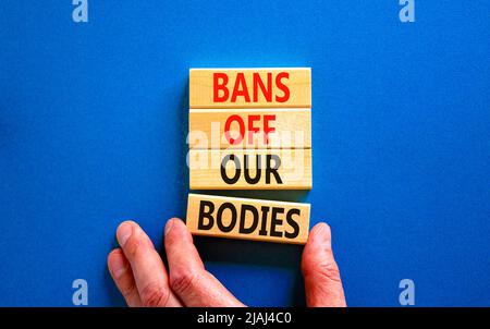 Bans off our bodies symbol. Concept words Bans off our bodies on wooden blocks on beautiful blue table blue background. Women rights concept. Business Stock Photo