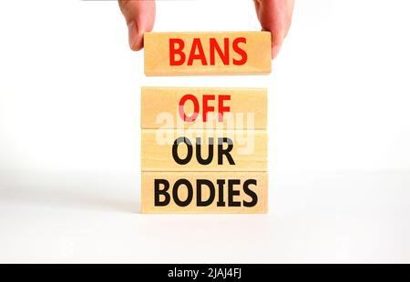 Bans off our bodies symbol. Concept words Bans off our bodies on wooden blocks on beautiful white table white background. Women rights concept. Busine Stock Photo