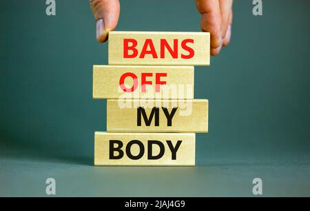 Bans off my body symbol. Concept words Bans off my body on wooden blocks on a beautiful grey table grey background. Women rights concept. Business soc Stock Photo