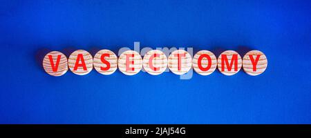 Vasectomy symbol. Concept words Vasectomy on wooden circles. Beautiful blue table blue background. Medical and vasectomy problem concept. Conceptual i Stock Photo