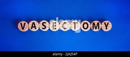 Vasectomy symbol. Concept words Vasectomy on wooden circles. Beautiful blue table blue background. Medical and vasectomy problem concept. Conceptual i Stock Photo