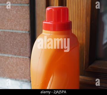 disposable single use rigid orange plastic detergent bottle Stock Photo