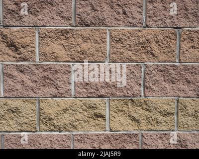 brown and yellow stone bricks wall useful as a background Stock Photo