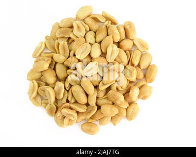 Peeled salted peanuts on a white background. Heap of roasted peanuts without husks close-up. Salted nuts, snacks for beer top view. Stock Photo