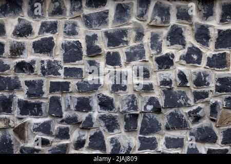 Paving stone walkway abstract background. Rock texture. Dark grey brick wall. Abstract gray grunge texture. Grey granite surface, floor. Stock Photo