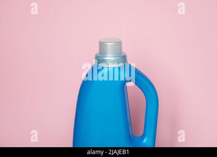 Large blue plastic bottle with gel for washing isolated on a pink background. Laundry container, merchandise template. Stock Photo