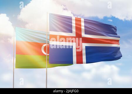 Sunny blue sky and flags of iceland and azerbaijan Stock Photo