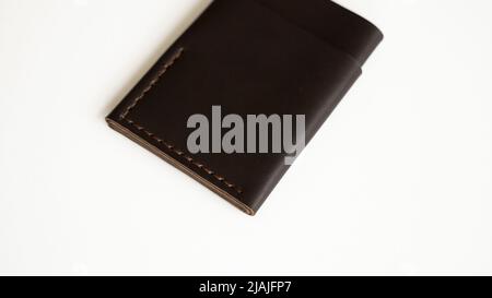 Brown empty men's business handmade leather card holder with isolated on white background. Selective focus, copy space, close up. Stock Photo