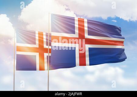 Sunny blue sky and flags of iceland and iceland Stock Photo