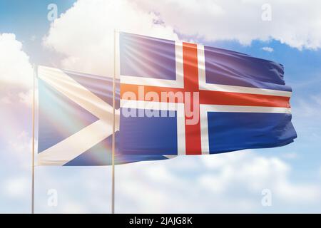 Sunny blue sky and flags of iceland and scotland Stock Photo