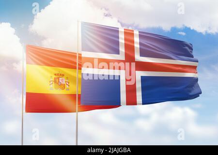 Sunny blue sky and flags of iceland and spain Stock Photo